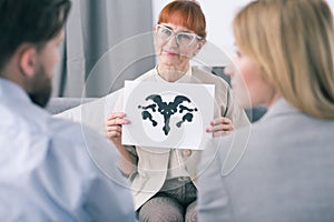 Therapist doing an inkblot test with her patients photo