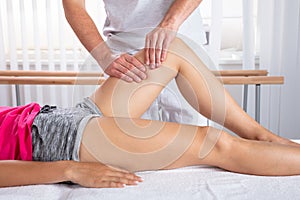 Therapist Giving Knee Massage To Woman