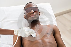 Therapist Giving Laser Epilation On Man`s Chest