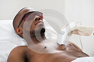 Therapist Giving Laser Epilation On Man's Chest