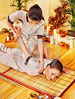 Therapist giving stretching massage to woman.