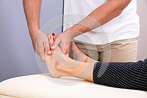 Therapist Hand Giving Foot Massage To Woman