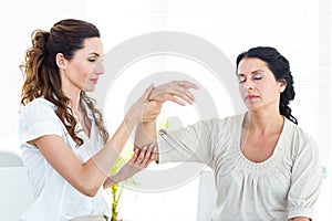 Therapist holding her patients arm