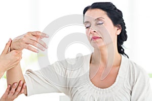 Therapist holding her patients arm