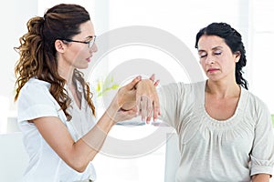 Therapist holding her patients arm