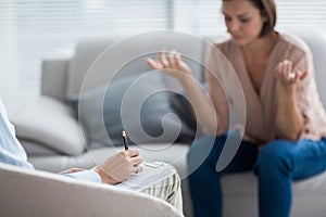 Therapist making notes of patient photo