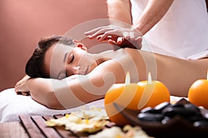 Therapist Giving Back Massage To Young Woman photo