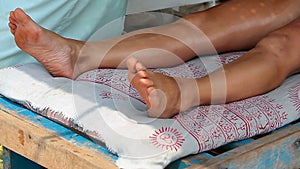 Therapist`s hands doing legs massage