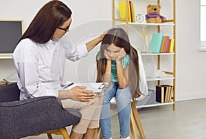 Therapist or school psychologist helping and supporting sad, stressed, depressed child