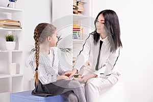 Therapist session concept. Female psychologist working with cute little child.