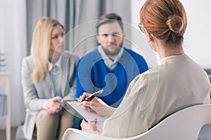 Therapist talking to a couple with problems photo