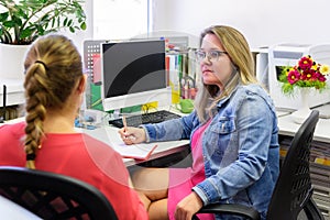 Therapist talking to a young mother after assessing her daughter in complex needs child therapy session.