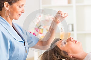 Therapist using pendulum