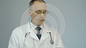 Therapist using tablet PC to check patient's medical record or lab test results