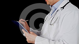 Therapist writing o clip board on black background. Male doctor in medical gown writing notes in clipboart while patient