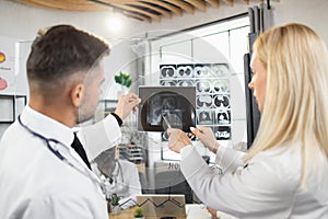 Therapists examining together mri scan during meeting