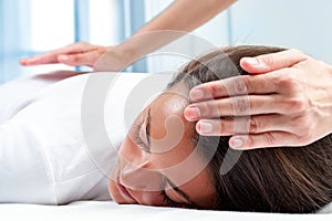 Therapists hands doing reiki therapy on girl. photo