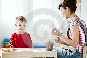 In therapy, kid is learning skills that don`t come naturally because of ADHD, like listening and paying attention better photo