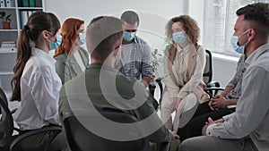 therapy sessions in quarantine, young men and women wearing medical masks to protect against virus and infection share