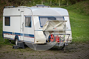 there are 2 gas cylinders in the storage space of a caravan