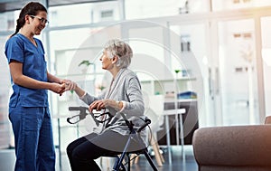 Is there anything I can do for you. a young female nurse talking to her senior patient in the old age home.