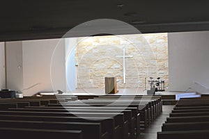There is a beautiful light and shadow cross inside the solemn church photo