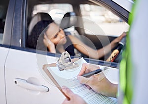 There are consequences if you disobey the law. Closeup shot of a traffic officer issuing a woman with a ticket.