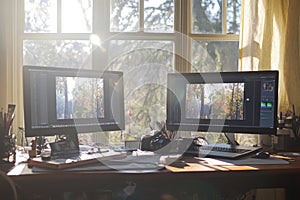 There is a desk featuring three computer monitors set up in a room