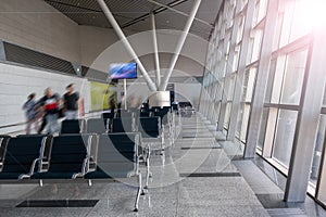 There are empty chairs, benches for passengers waiting for flights at the airport terminal, selected focus