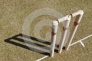 there is an empty cricket field and bat to hit a ball