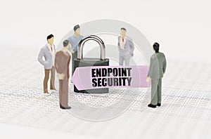 There are figures of people on business reports, a padlock with a sticker on which it is written - Endpoint security