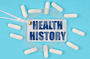 There is a label on the table among the pills that says - HEALTH HISTORY