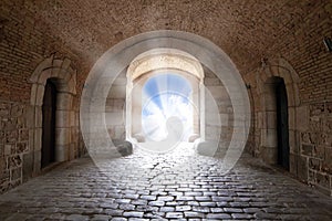 There is the light sky in the end of arch in a tunnel