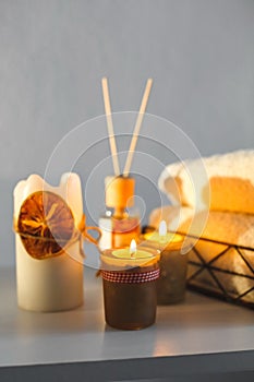 There are lighted aromatic candles on the table, towels for procedures lie