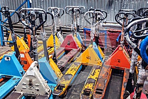 there are a lot of old hydraulic trolleys in stock. mechanical equipment for moving goods manually