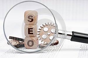 There is a magnifying glass on the documents that points to the cubes with the inscription - SEO