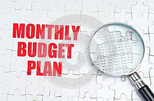 There is a magnifying glass on the puzzles, next to it is written - Monthly budget plan