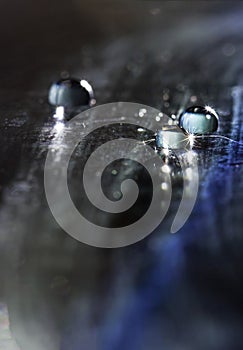 There are many beautiful dreamy transparent water drop on the table