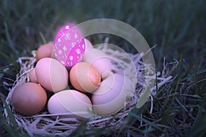 There are many eggs that are stacked together and have pink eggs is decorated with colorful colors are floral patterns put on top