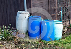 There are many rain barrels in the garden