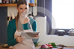 There are so many recipes to choose from. Portrait of a young woman looking for online recipes on her digital tablet.