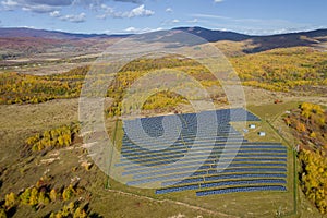 There are many solar panels near the forest. Ecology concept with solar panels. View from above photo
