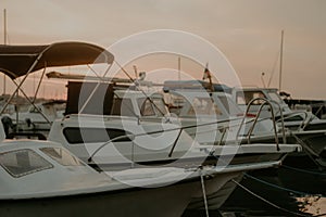 There are many yachts, boats and ships at sea. Marina at sunset