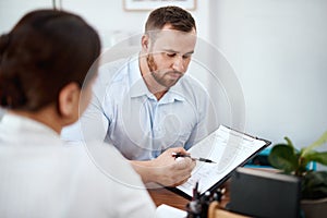 There might be some stipulations youre unaware of. a car salesman explaining a contract to a customer thats about to photo