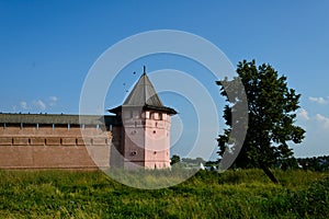 A monastery with red walland green tree photo