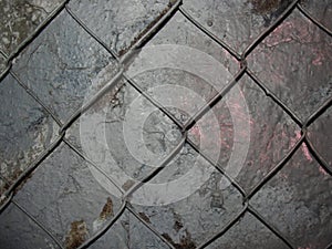 Chain link mesh on a gray painted background - vandal-proof protection of municipal and departmental property. no graffiti
