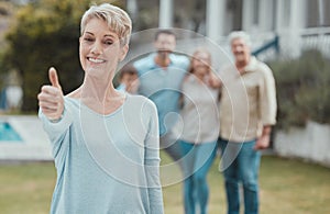 There are no other people Id rather call family. a mature woman showing a thumbs up in the garden at home.