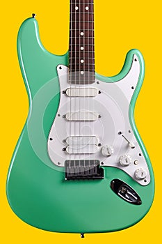 Electric Guitar in. Bright Surf Seafoam Green - Rock Band Guitarist Musician, Yellow Background photo