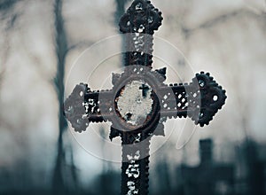 There is an old rusty cross in the cemetery, on which Catholic rosaries hang. Horror at nightfall