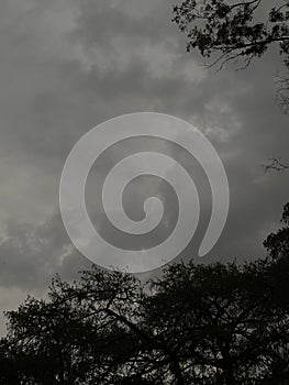 there is a plane flying in the sky during a cloudy day